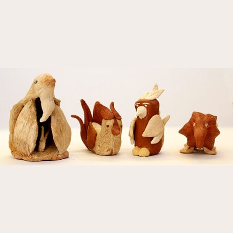 Four small animal figures made from natural materials, resembling a bird and various mammals.