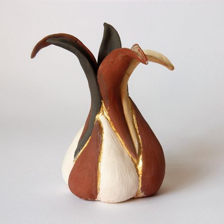 Ceramic vase with abstract, flowing shapes in earthy tones and a gold accent.