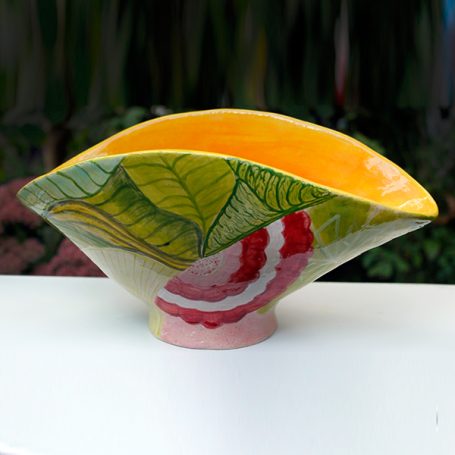 Decorative ceramic bowl with vibrant yellow and green leaf motifs.