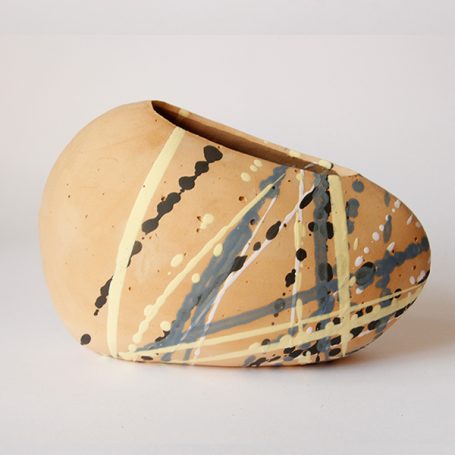 Ceramic vase with an organic shape and abstract painted stripes in black and blue.